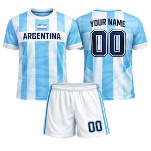 May include: A light blue and white Argentina football kit. The jersey has vertical stripes, the word "ARGENTINA", and a flag graphic. The shorts are white with blue trim and the number "00". The back of the jersey has the text "YOUR NAME" and the number "00".