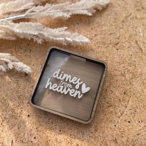 May include: A wooden box with a clear acrylic insert. The box has the words "dimes from heaven" and a heart printed on it.