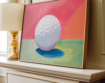 May include: A painting of a white golf ball on a green and pink background. The golf ball is in the center of the painting and is surrounded by a blue shadow.