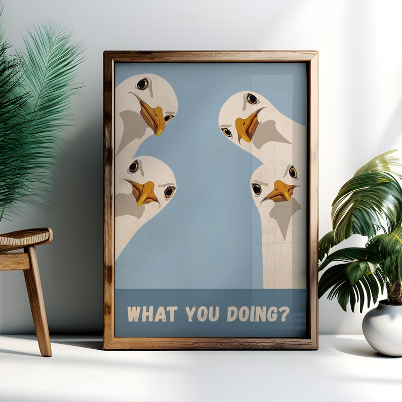 May include: Framed art print featuring four cartoon geese with white feathers, yellow beaks, and black eyes, set against a light blue background. The text "WHAT YOU DOING?" is displayed in a white font at the bottom of the print.