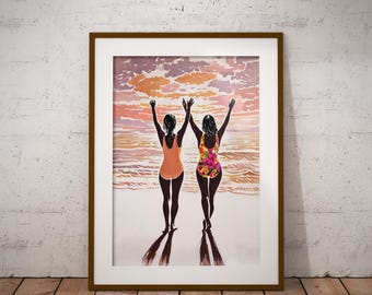 May include: Framed art print depicting two figures in swimsuits with arms raised, facing a sunset over the ocean. One swimsuit is orange, the other is floral. The artwork is framed in a brown wooden frame and set against a white wall and wooden floor.