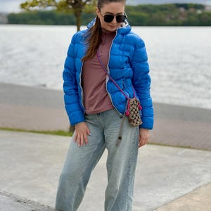 Eco-friendly cotton cord pouch with adjustable crossbody strap.