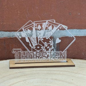 May include: A clear acrylic plaque featuring a design of playing cards and dice. The name "Thorsten" is written in a decorative font at the bottom of the plaque.