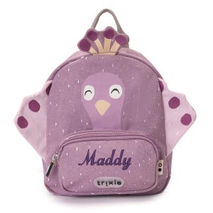 May include: A purple backpack with a bird design, featuring a front pocket with the name "Maddy" in cursive. The backpack has a handle and wings with purple polka dots. The brand name "trixie" is printed on the front pocket.