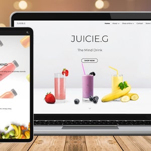 Könnte beinhalten: Eine Website-Design für "JUICIE.G", "The Mind Drink", wird auf einem Laptop, Tablet und Smartphone angezeigt. Die Website zeigt Bilder von Frucht-Smoothies und Saftflaschen. Das Tablet zeigt den Text "SHARPEN YOUR MIND".