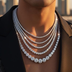 Puede incluir: Conjunto de seis collares de diamantes de diferentes longitudes. Los collares están compuestos por diamantes redondos con talla brillante, siendo las piedras más grandes las de la base. La joyería destaca sobre un fondo oscuro, resaltando el brillo de las gemas.