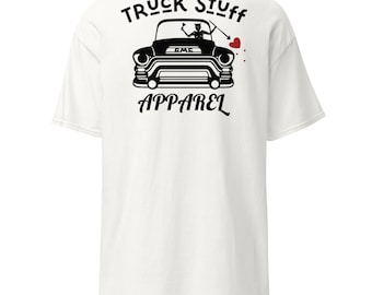 May include: White t-shirt with a black graphic of a vintage GMC truck. The graphic includes the text "Truck Stuff Apparel" above and below the truck image. A devil figure is inside the truck, with an arrow and heart.