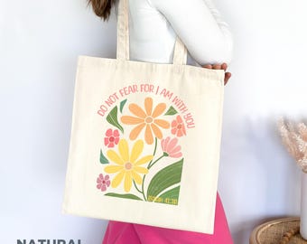 May include: A white canvas tote bag with a floral design and the text "Do not fear for I am with you Isaiah 41:10".