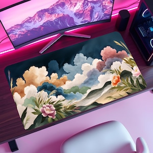 May include: A white ceramic mug with a black handle and the text "But First, Coffee" in a bold, black font. The mug is set against a blurred background. The mug is approximately 10 cm tall.