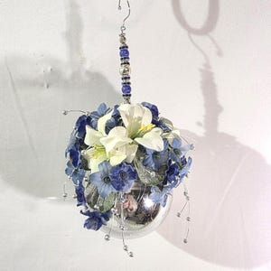 Christmas tree ornament shiny silver ball with white and blue flowers and beaded hanger