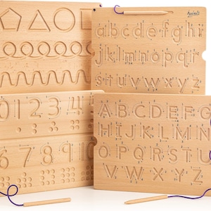May include: Four wooden tracing boards with a purple string and wooden stylus. The boards feature uppercase and lowercase letters, numbers, and basic shapes. The boards are labeled "hulats".