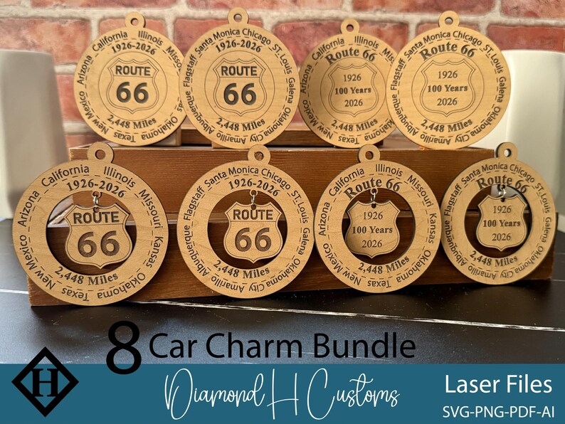 May include: A bundle of eight Route 66 car charms made of light-colored wood. Each charm features the Route 66 shield logo, the years 1926-2026, and the distance of 2,448 miles. The charms are laser cut and have a hole for hanging.