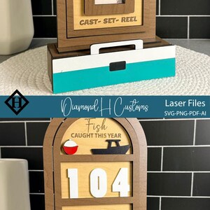 May include: Wooden fishing-themed decor with a brown frame and a light wood interior. The design includes a fish-shaped ruler, the words "Gone Fishing" and "Cast-Set-Reel". The base has a white and teal stripe.