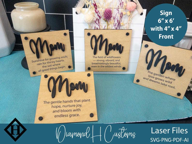 May include: Four wooden signs with the word "Mom" in black lettering and inspirational quotes about mothers. The signs are 6 inches by 6 inches with a 4 inch by 4 inch front. The signs are on a blue surface.