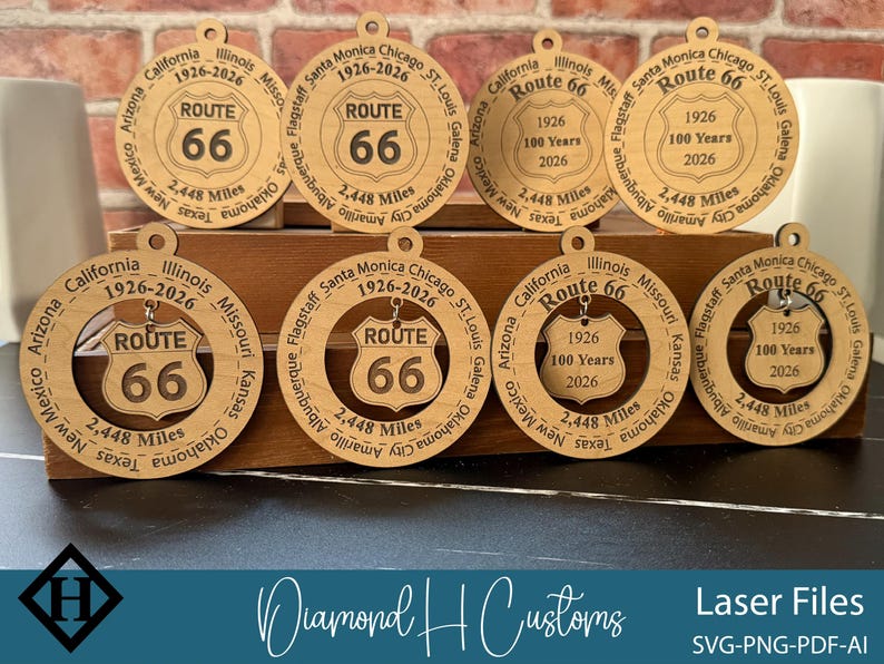 May include: Wooden Route 66 ornaments with a circular design. Each ornament features the Route 66 shield, the years 1926-2026, and the text "2,448 Miles." The ornaments are laser cut and include various state names.