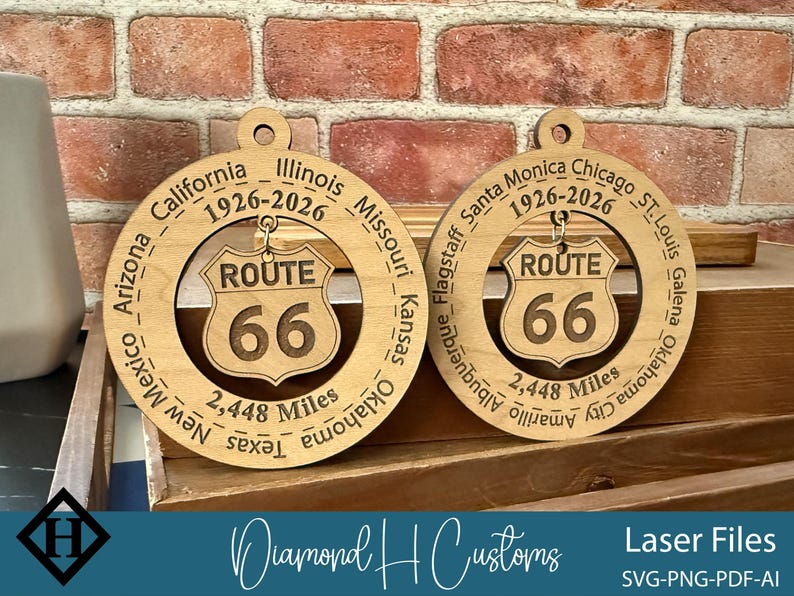 May include: Two wooden Route 66 ornaments. Each ornament features a circular design with the route's name and the number 66 in the center. The outer ring includes the names of cities and states along the route, and the distance of 2,448 miles.