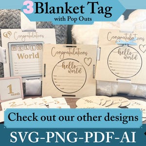 May include: Three wooden blanket tags with pop-out elements. The tags are decorated with the text "Congratulations", "Hello World", and a circle with the text "Hello World". The tags are designed for a baby shower or new baby gift.
