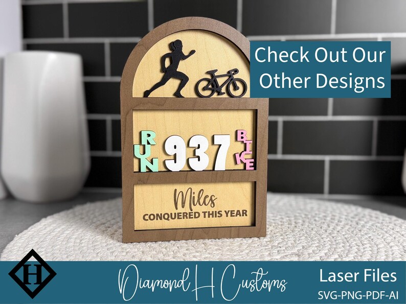 May include: Wooden fitness tracker with a runner and bicycle silhouette. The display shows "RUN 937 BIKE" and "Miles CONQUERED THIS YEAR". The text "Check Out Our Other Designs" is also visible.