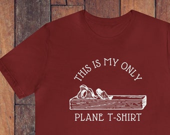 May include: A maroon t-shirt with a white graphic of a wood plane and the text "This is my only plane t-shirt."