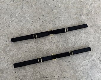 set of 2 black adjustable thigh garters with gold color accessories