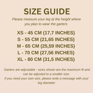 May include: A size guide chart for leg garters with dark brown text on a light beige background. It lists sizes XS through XL with measurements in centimeters and inches, noting that garters are adjustable and custom sizes are available.