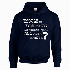 May include: A navy blue hooded sweatshirt with the text "Why is this shirt different from all other shirts?" in white. The text includes Hebrew characters.