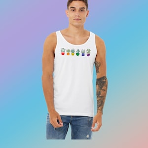 May include: A white tank top with a rainbow of potted plants printed on the front. The plants are in different colored pots, each representing a color of the rainbow.