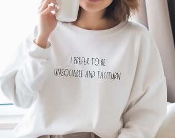May include: White sweatshirt with the text "I prefer to be unsociable and taciturn" printed on the front.