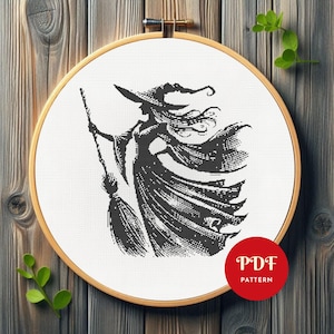 May include: A black and white cross-stitch design of a witch with a broom, displayed in a wooden embroidery hoop. The witch wears a hat and flowing dress. A red circle with "PDF PATTERN" is in the lower right corner.