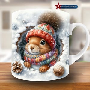 May include: White ceramic mug with a winter design. It shows a squirrel wearing a red and green knitted hat and scarf, surrounded by snow and snowflakes. A pine cone and a nut are also visible. The mug has a white handle and the text "9 Free Designs Included".