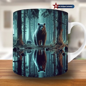 May include: A white ceramic mug with a black bear and its reflection in a pool of water in a forest setting. The mug has a black handle.