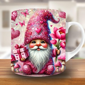 May include: A white ceramic mug with a pink and white gnome holding a gift box. The gnome is wearing a pink hat with hearts and glitter. The mug has a pink and white floral design with hearts and glitter.