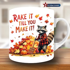 May include: White ceramic mug featuring a raccoon in a red plaid shirt raking leaves. The mug has the text "Rake it Till You Make It!" with autumn leaves and a pumpkin. Includes 9 free designs.