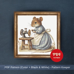 May include: Cross-stitch design featuring a mouse in a blue dress and white apron, sewing with a small sewing machine. The artwork is framed in a wooden frame. The image includes the text "PDF Pattern" in a red circle and "PDF Pattern (Color + Black & White) - Pattern Keeper".