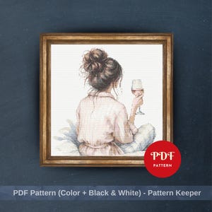 Puede incluir: Patrón de punto de cruz de una persona con una camisa rosa y pantalones a cuadros, sosteniendo una copa de vino. La obra de arte está enmarcada en un marco dorado. La imagen incluye el texto "PDF Pattern" en un círculo rojo y "PDF Pattern (Color + Black & White) - Pattern Keeper".