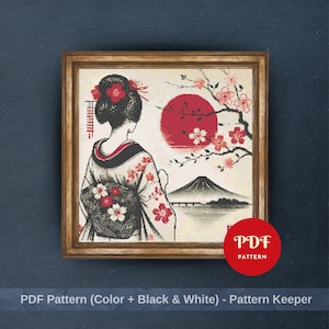 May include: Framed cross-stitch pattern featuring a geisha in a kimono, with a red sun, cherry blossoms, and a mountain landscape. The artwork is in a wooden frame. The image includes the text "PDF Pattern (Color + Black & White) - Pattern Keeper".