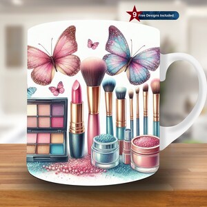 May include: White ceramic mug with a colorful design featuring makeup brushes, lipstick, eyeshadow palettes, and butterflies. The design includes pink, blue, and gold accents.