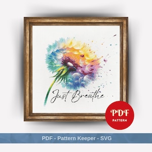 Könnte beinhalten: Ein farbenfrohes Aquarellbild eines Löwenzahns mit dem darunter gedruckten Text "Just Breathe..." Der Löwenzahn ist eine lebendige Mischung aus Blau, Grün, Gelb und Lila.