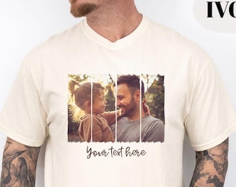 May include: Ivory-colored t-shirt featuring a framed photo of a person and a child. The photo is divided into three vertical sections. The text "Your text here" is written in a cursive font below the photo.