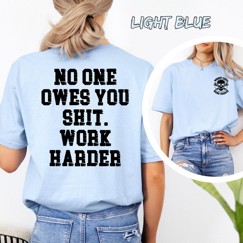 May include: Light blue t-shirts with black text. One shirt has the text "NO ONE OWES YOU SHIT. WORK HARDER" on the back. Another shirt has a skull graphic and the text "NOBODY CARES. WORK HARDER".