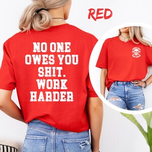 May include: A red t-shirt with white text on the back that reads "NO ONE OWES YOU SHIT. WORK HARDER." The shirt also has a small graphic on the front with a skull and the words "HOBBY CARTS WORK HARDER."