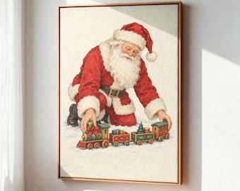 May include: A framed canvas print depicting Santa Claus with a white beard and red suit with white fur trim, kneeling in the snow. Santa is placing a hand on a colorful toy train set consisting of a locomotive and three small train cars.
