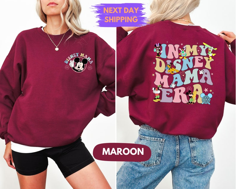 May include: A maroon sweatshirt with a Mickey Mouse graphic on the front and the text "In My Disney Mama Era" with various Disney characters on the back.