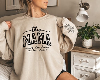 This Mama Wears Her Heart On Her Sleeve Sweatshirt for Mothers Day, Mother Day Gift for Mom, Custom Mama Sweater with kids Name on Sleeve