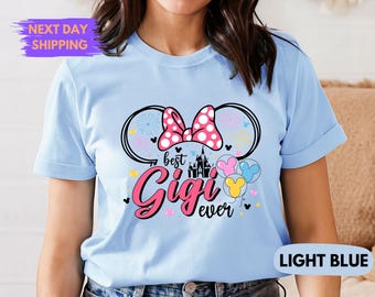 May include: Light blue t-shirt with a pink and white Minnie Mouse ears design and the text "Best Gigi Ever".