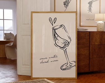以下が含まれることがあります： ワイングラスの黒い線画と水しぶき、そして筆記体で「save water drink wine」という文字が描かれた、縦型の額入りウォールアートプリント。明るいクリーム色の背景に、明るい木製のフレームが施されています。