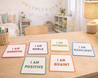 May include: Six square cards with colorful borders and the words "I AM MINDFUL", "I AM NOBLE", "I AM OPTIMISTIC", "I AM RESILIENT", "I AM POSITIVE", and "I AM QUAINT" printed on them. The cards are arranged on a light wooden surface.