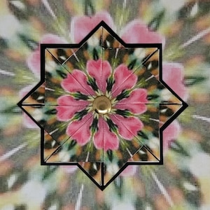 May include: A star-shaped paper ornament featuring a central gold-toned metal brad. The design displays a repeating pattern of pink petal-like shapes radiating outward, accented by dark green and black lines against a blurred, multi-colored background.