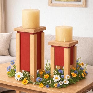 May include: Two wooden candle holders with red centers and light-colored wood accents. Each holder has a beige pillar candle on top. The holders are surrounded by a floral arrangement of daisies, blue and yellow flowers.