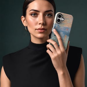 May include: A phone case with an impressionist painting design in blue, orange, and green. The case has a black border and a camera cutout. The phone case is held by a person.